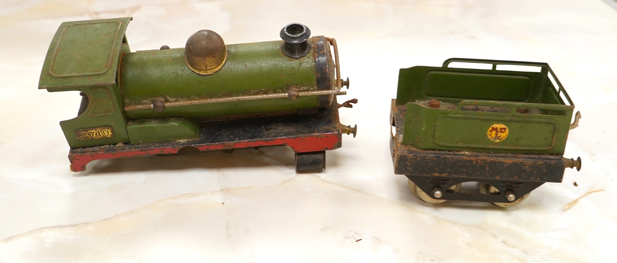 A Bing for Bassett Lowke 0 gauge tinplate clockwork LNER Ivatt 4-4-0 tender locomotive, 4390, together with an early Hornby clockwork 0-4-0, 2710, in GNR green livery with Meccano Ltd roundels to locomotive splasher and